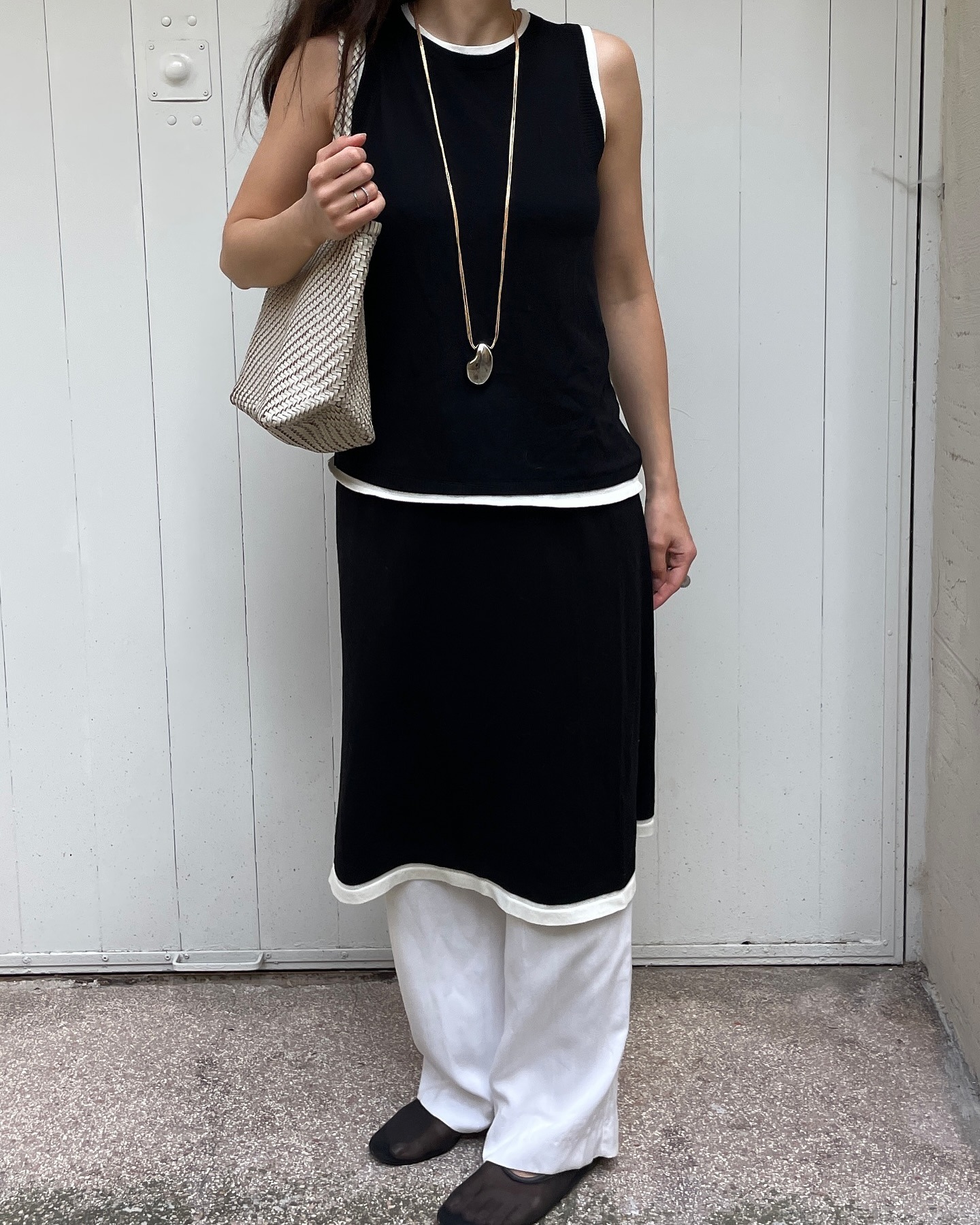 Influencer wearing chic, minimalist black and white outfit.
