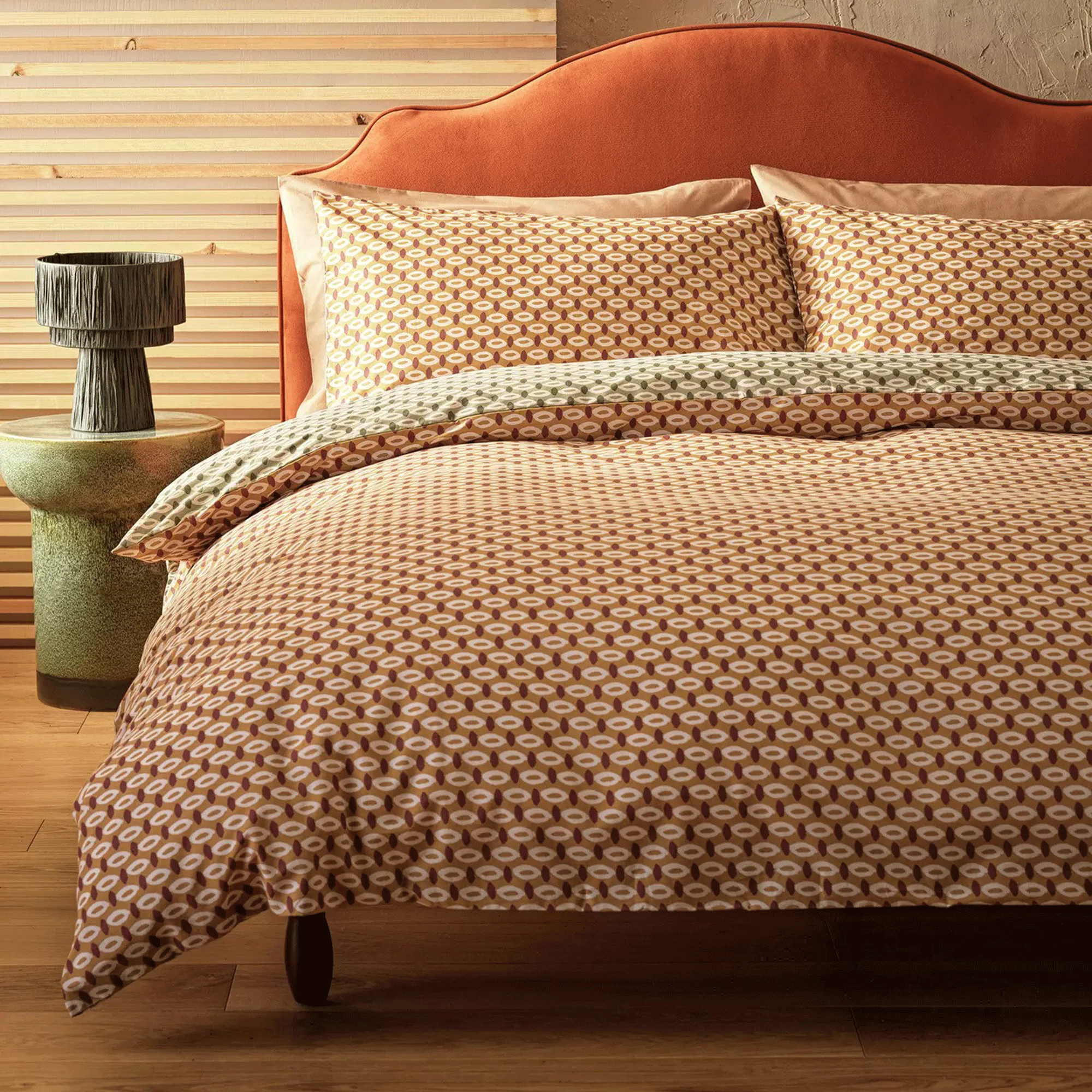Orange oval bedding with orange headboard
