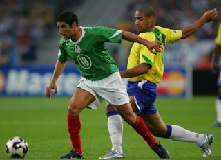 Mexico's Salvador Carmona holds off Brazil's Adriano in the 2005 Confederations Cup.