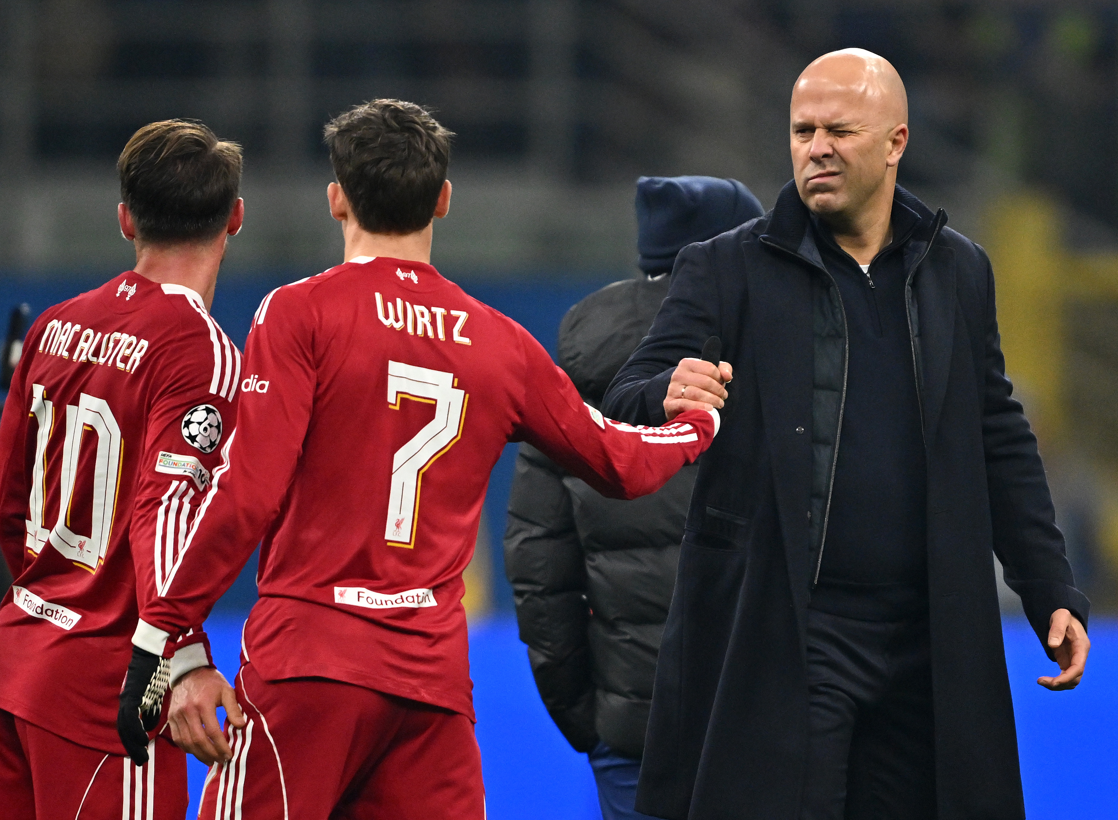 MILAN, ITALY - DECEMBER 09: (THE SUN OUT, THE SUN ON SUNDAY OUT ) Arne Slot, Manager of Liverpool, shakes hands with Florian Wirtz following the team&amp;apos;s victory during the UEFA Champions League 2025/26 League Phase MD6 match between FC Internazionale Milano and Liverpool FC at Stadio San Siro on December 09, 2025 in Milan, Italy. (Photo by Liverpool FC/Liverpool FC via Getty Images)