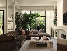 A living room with a brown sofa, a marble coffee table and large tree 