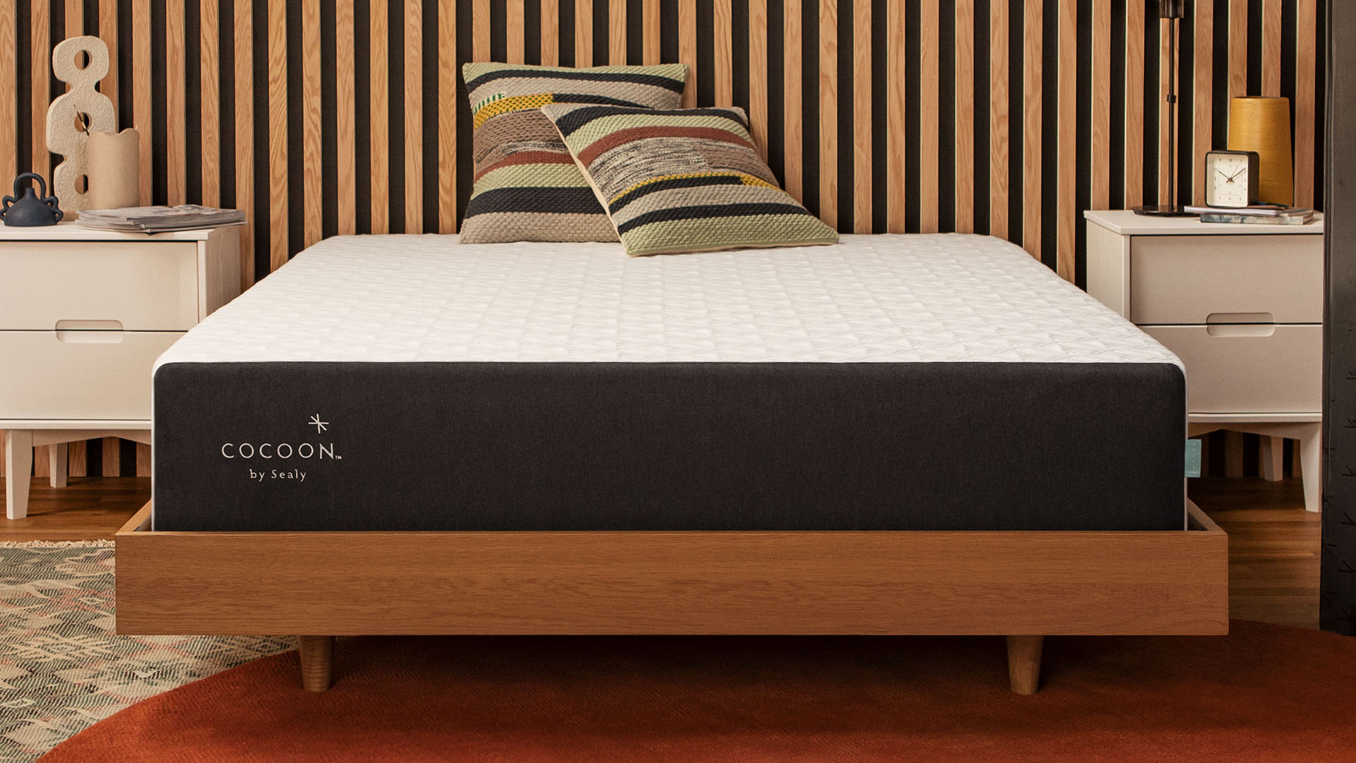 The Cocoon by Sealy Chill mattress, shown here in wood panelled bedroom, is the best queen mattress for hot sleepers on a small budget