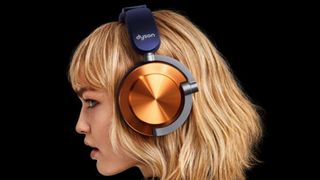 A person wearing Dyson OnTrac ANC headphones, shown from the side on a black background