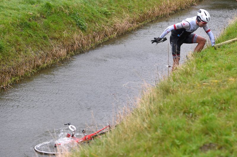 Gert Steegman climbs up the canal bank while his bike has a swim