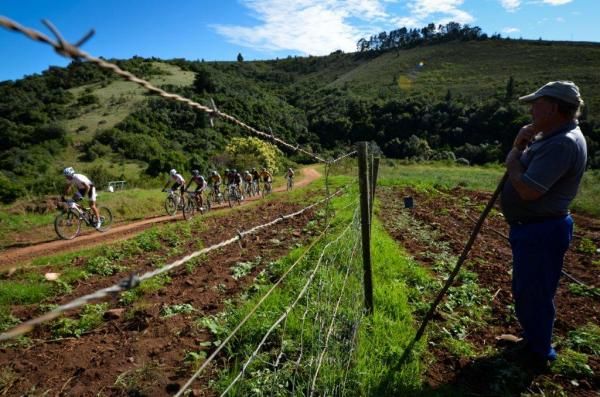 The race passes by a farmer in his field