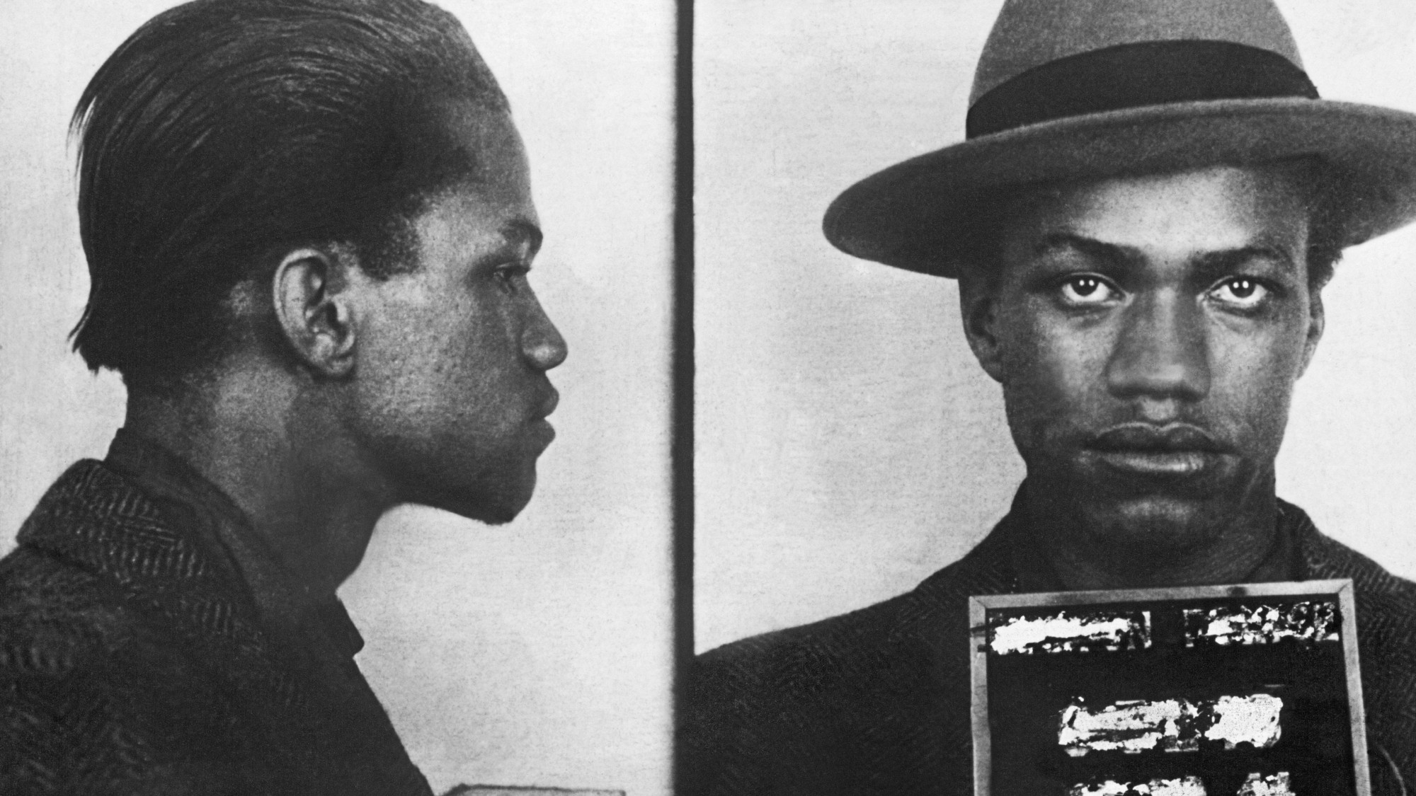 Black and white mugshot of Malcolm X aged 18