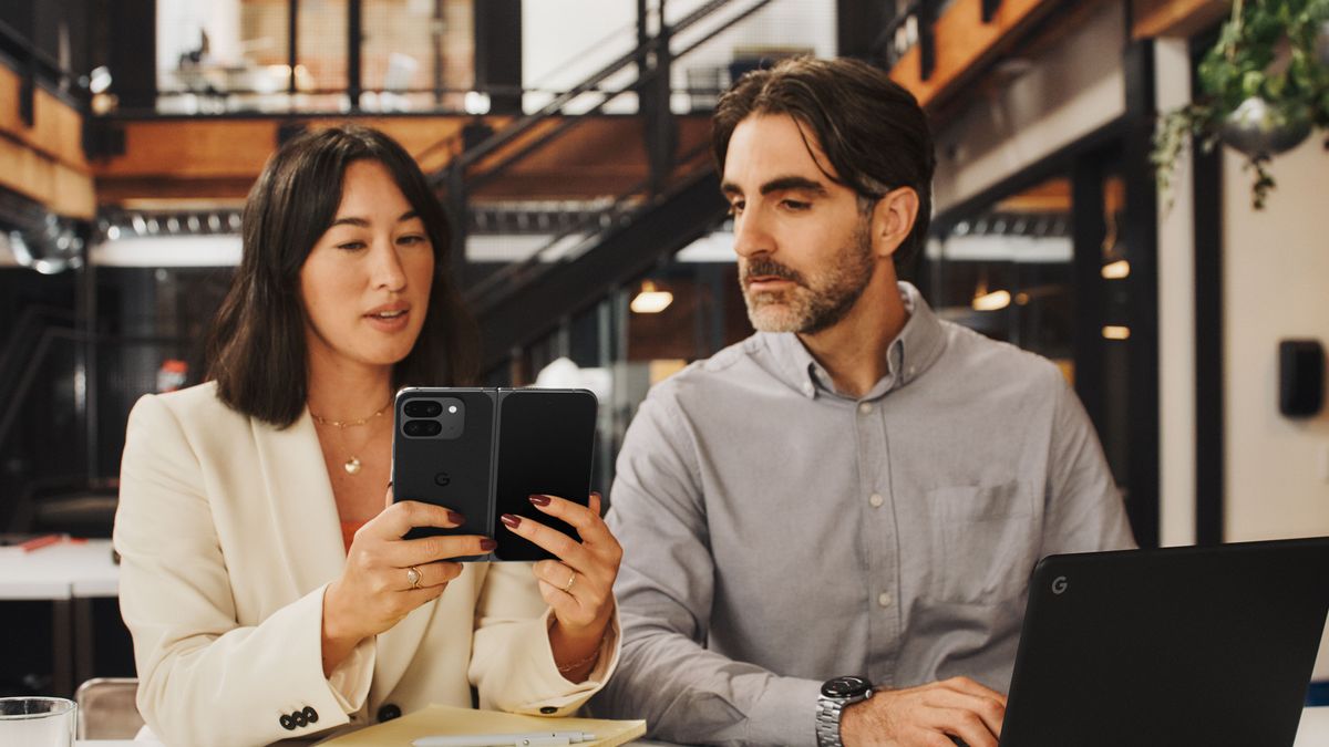 An image of the Google Pixel 9 Fold being held by a woman sitting next to a man indoors