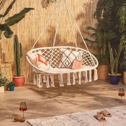 room with tiled flooring and double rope hanging chair