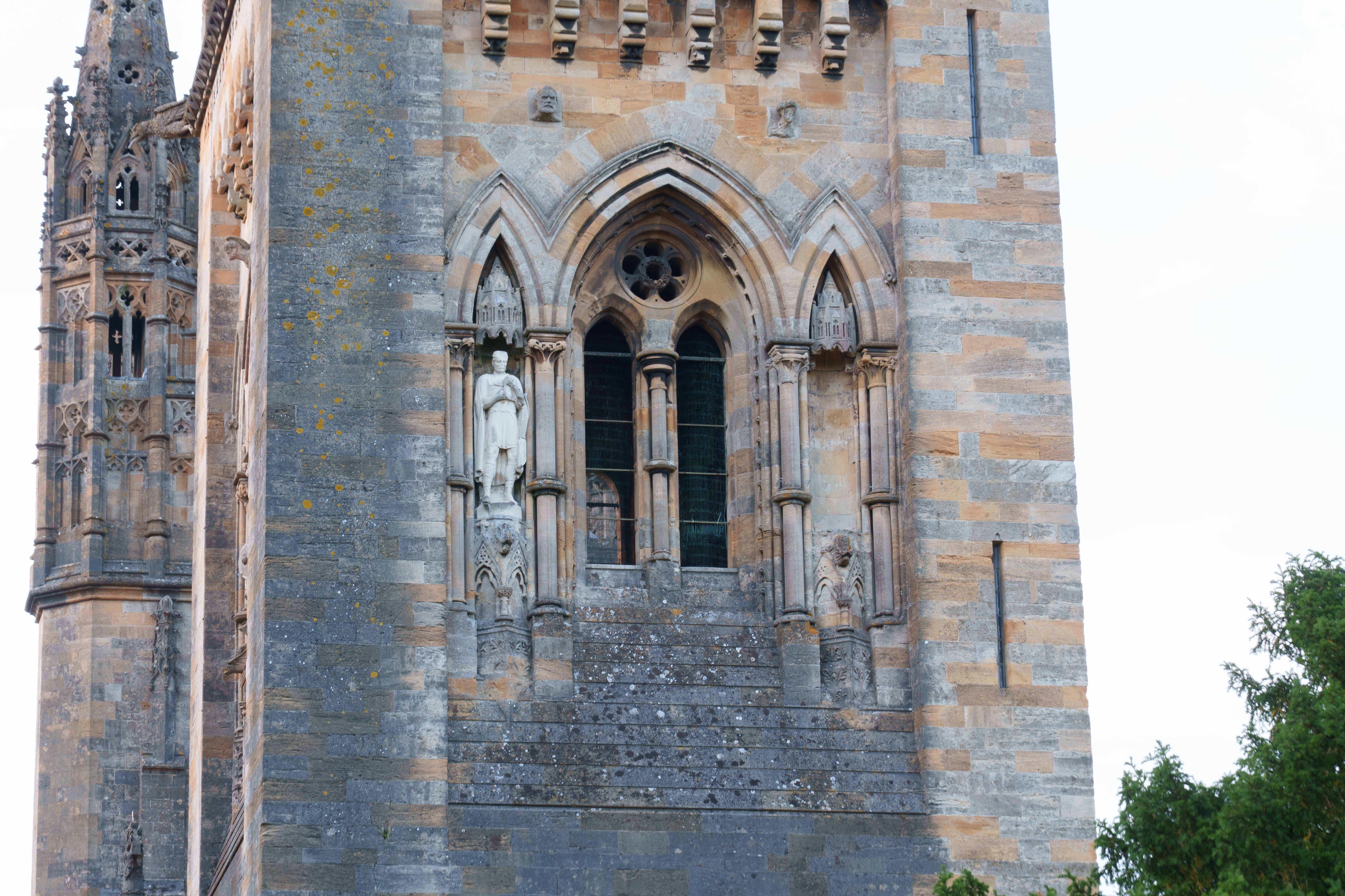 A photo of cathedral windows, statues and masonry.
