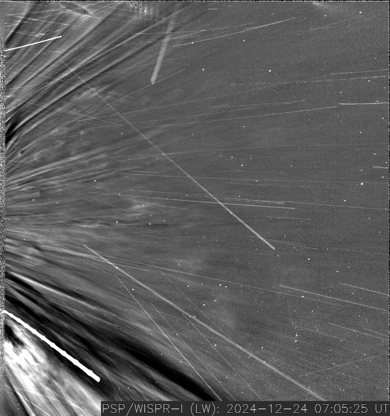A grayscale image shows a close up of the sun and shows a solar wind changing direction, curving to the left of the image
