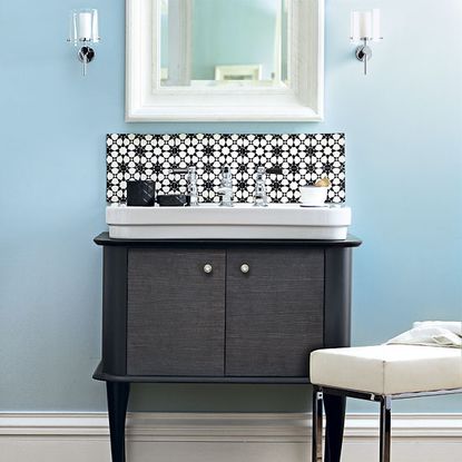 bathroom sink with wooden cabinet and mirror