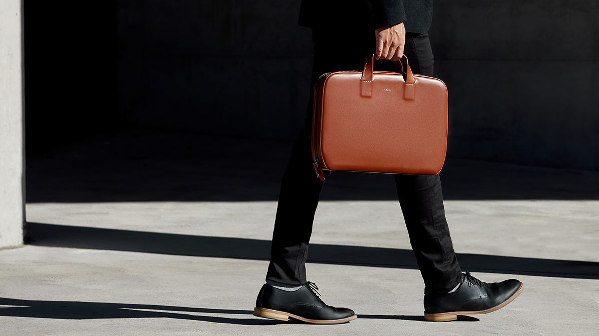 Man holding a leather briefcase