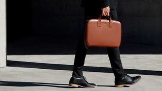 Man holding a leather briefcase