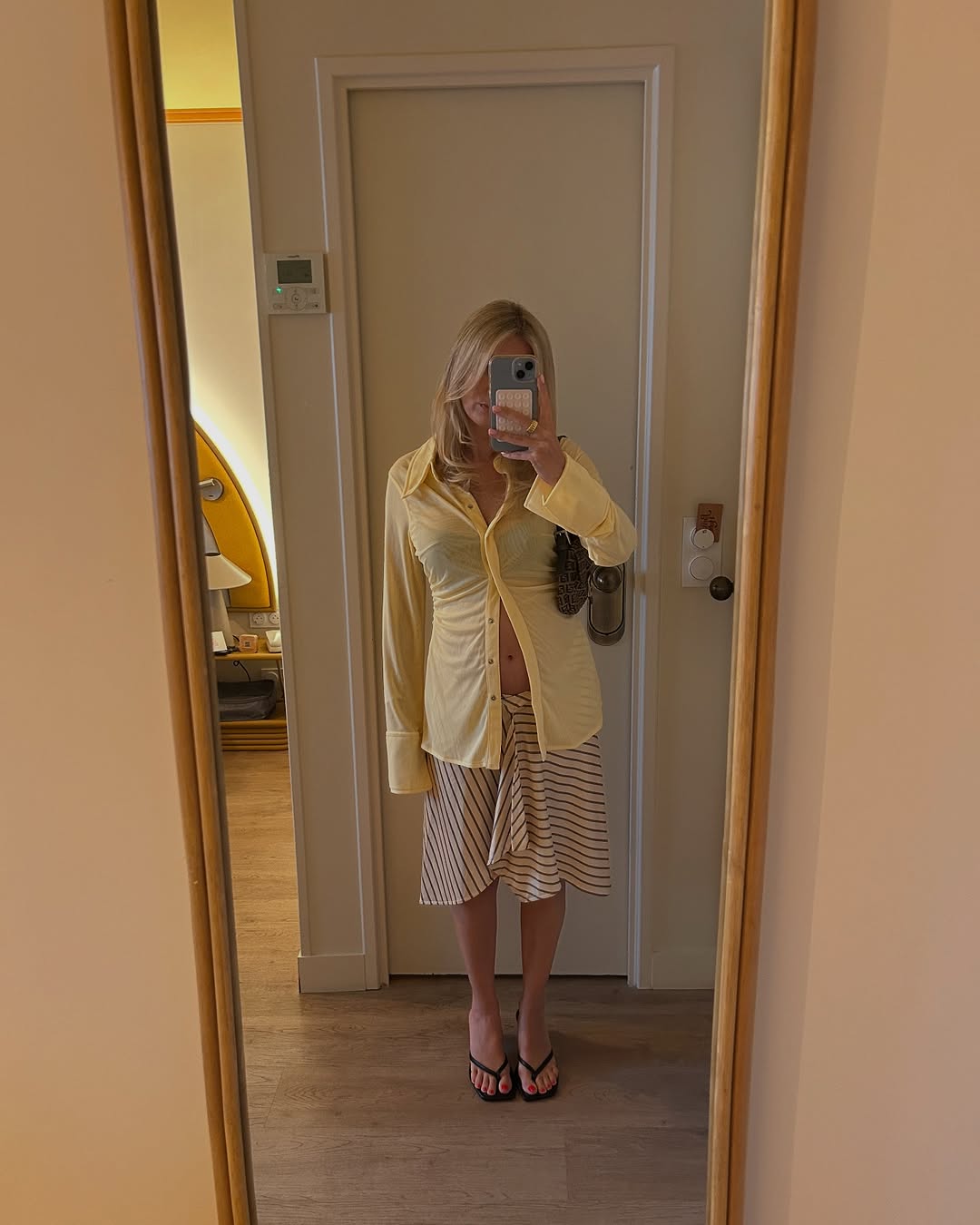 Woman wearing knee-length skirt outfit summer 2025.