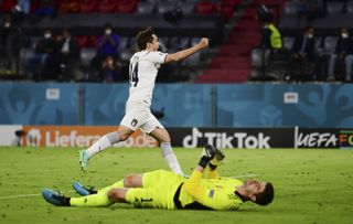 Belgium keeper Thibaut Courtois lies prone as Italy’s Federico Chiesa celebrates Lorenzo Insigne's goal