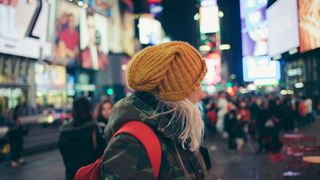 White hair girl with yellow winter hat in Times Square, New York City