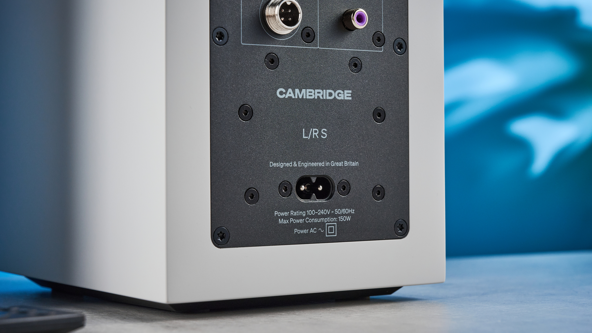 the cambridge audio l/r s bookshelf speakers in white with a 21mm aluminum tweeter and a 3-inch woofer photographed against the blue tom's guide background