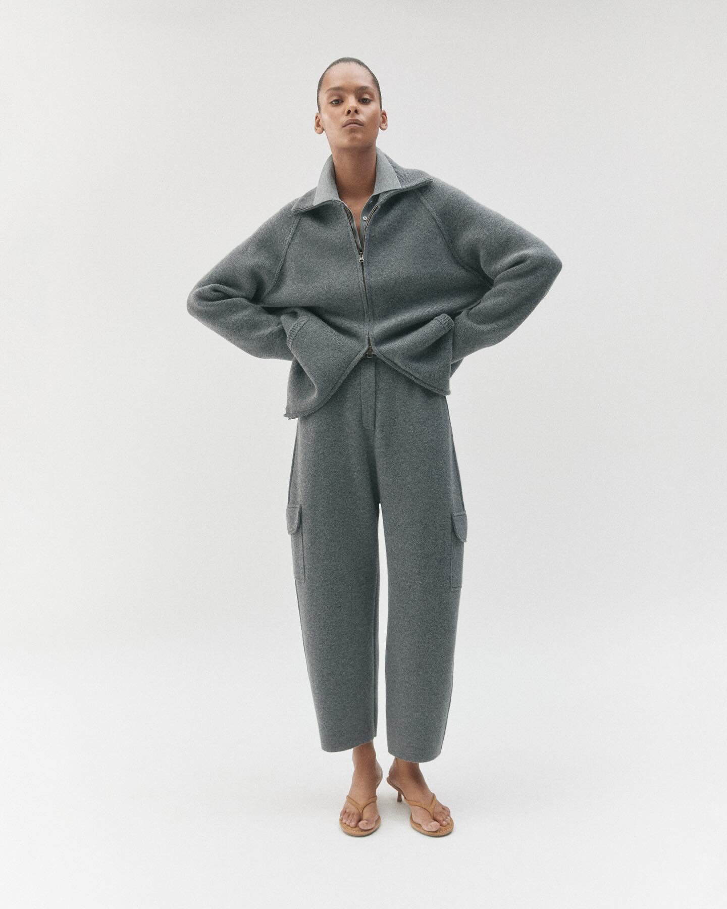 Lisa Yang campaign image showing a model wearing a grey cashmere jumper and trousers