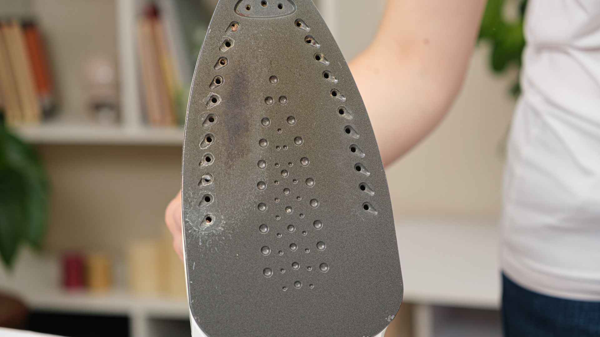 picture of clothes iron with brown limescale coming out of the steam holes