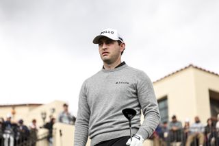 Patrick Cantlay looks on