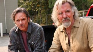 Pictured (L-R): Billy Burke as Vince Leone and Jeff Fahey as Walter Leone sitting next to each other in the back of a truck on Fire Country.