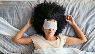 woman sleeping in bed with a face mask
