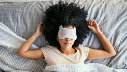 woman sleeping in bed with a face mask