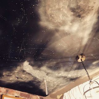 Ceiling with bricks white walls and candle