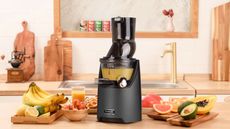 The best cold press juicer, the Kuvings EVO820, making tropical juice in a modern kitchen