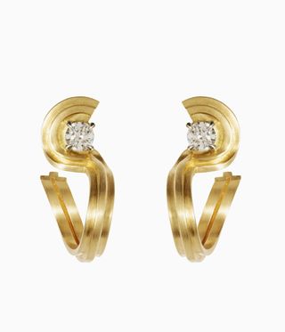 Gold curved earrings each with a single diamond