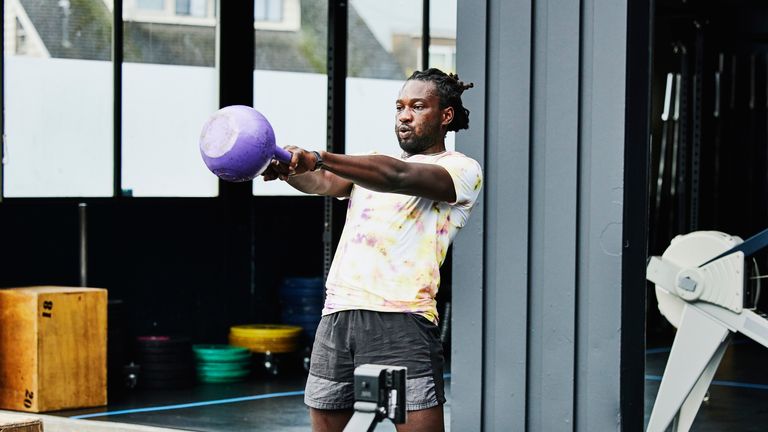 Man doing HIIT workouts with a kettlebell