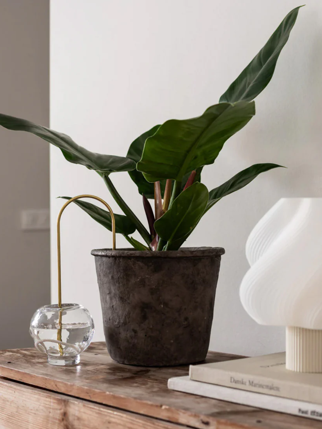 A gold plant straw feeding into a potted plant