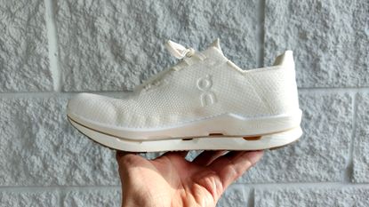 On Cloudneo shoes held in hand