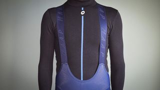 MAAP Apex winter bibtights being worn with a black long sleeve base layer