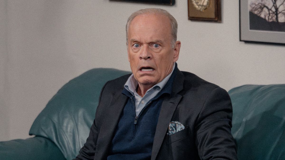 Frasier Crane looking shocked while sitting on a couch