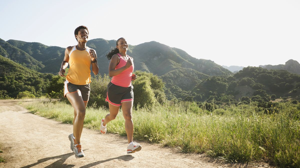 Women running together on remote trail