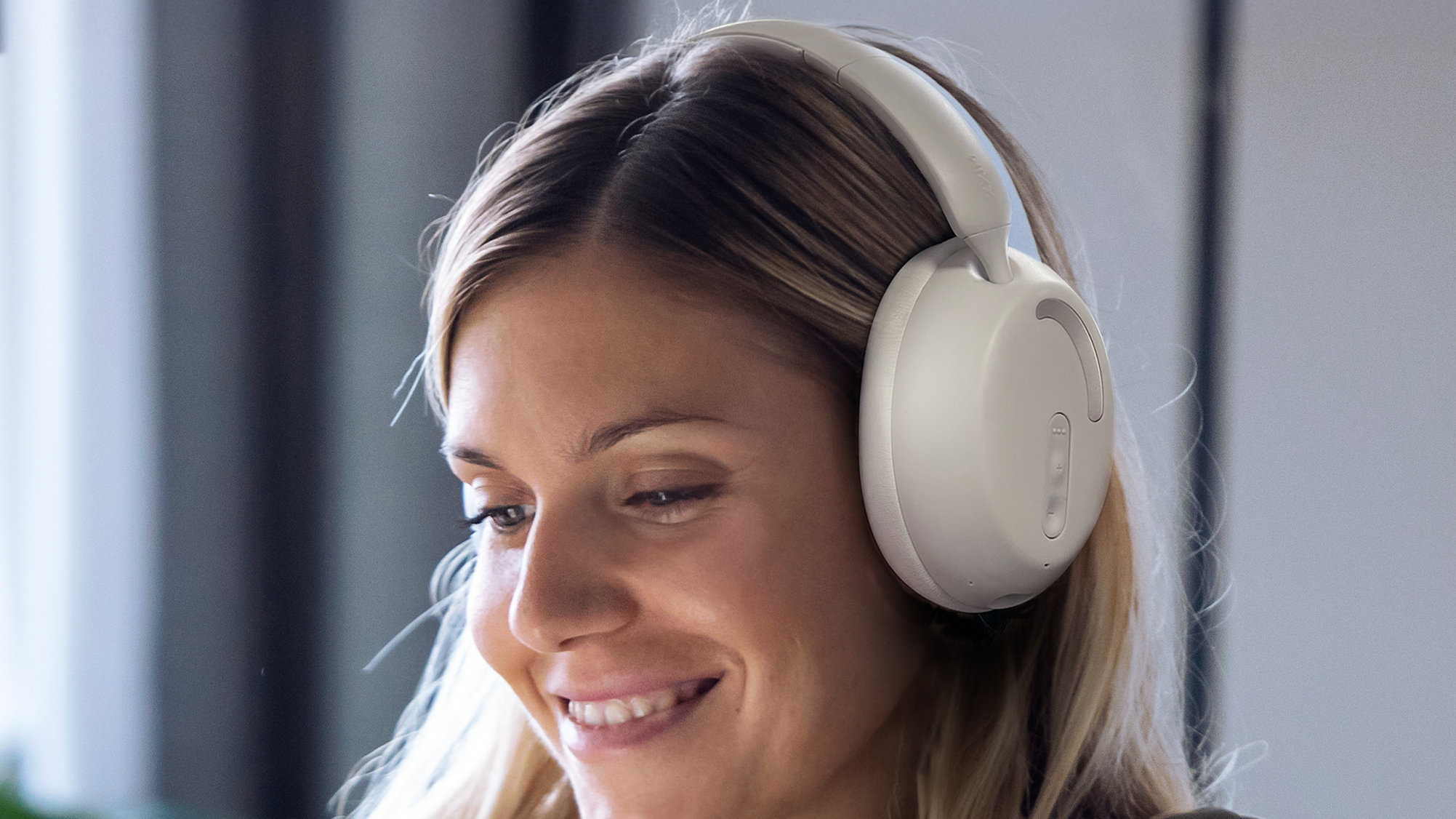 MIXX StreamQ D2 worn by a woman at home