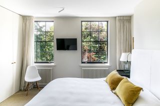 Livingetc-House-Tour-Modern-Home-Islington-Cream-Bedroom-with-Double-Windows-and-Built-in-Storage