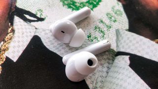 Oppo Enco Free2 earbuds lying casually on an album sleeve