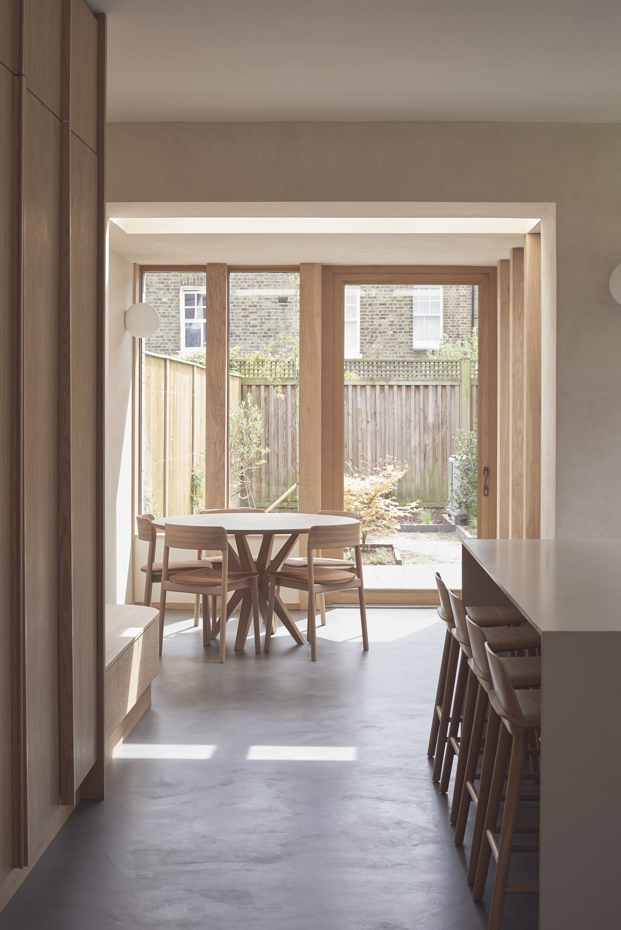 view to garden through timber windows in dining room