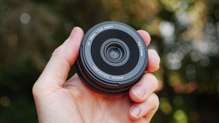 Viltrox AF 26mm F2.8 EVO 'pancake' lens in TechRadar's Cameras Editor Tim Coleman's hand