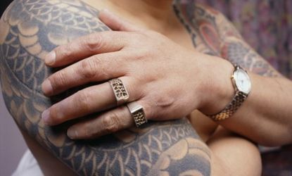 A former Yakuza member, who had two fingers cut off to make amends, shows off his prosthetic fingers and tattoos: The Obama administration has imposed sanctions on the gang's largest clan.
