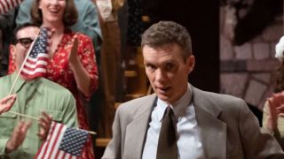 Cillian Murphy in Oppenheimer with flags behind him