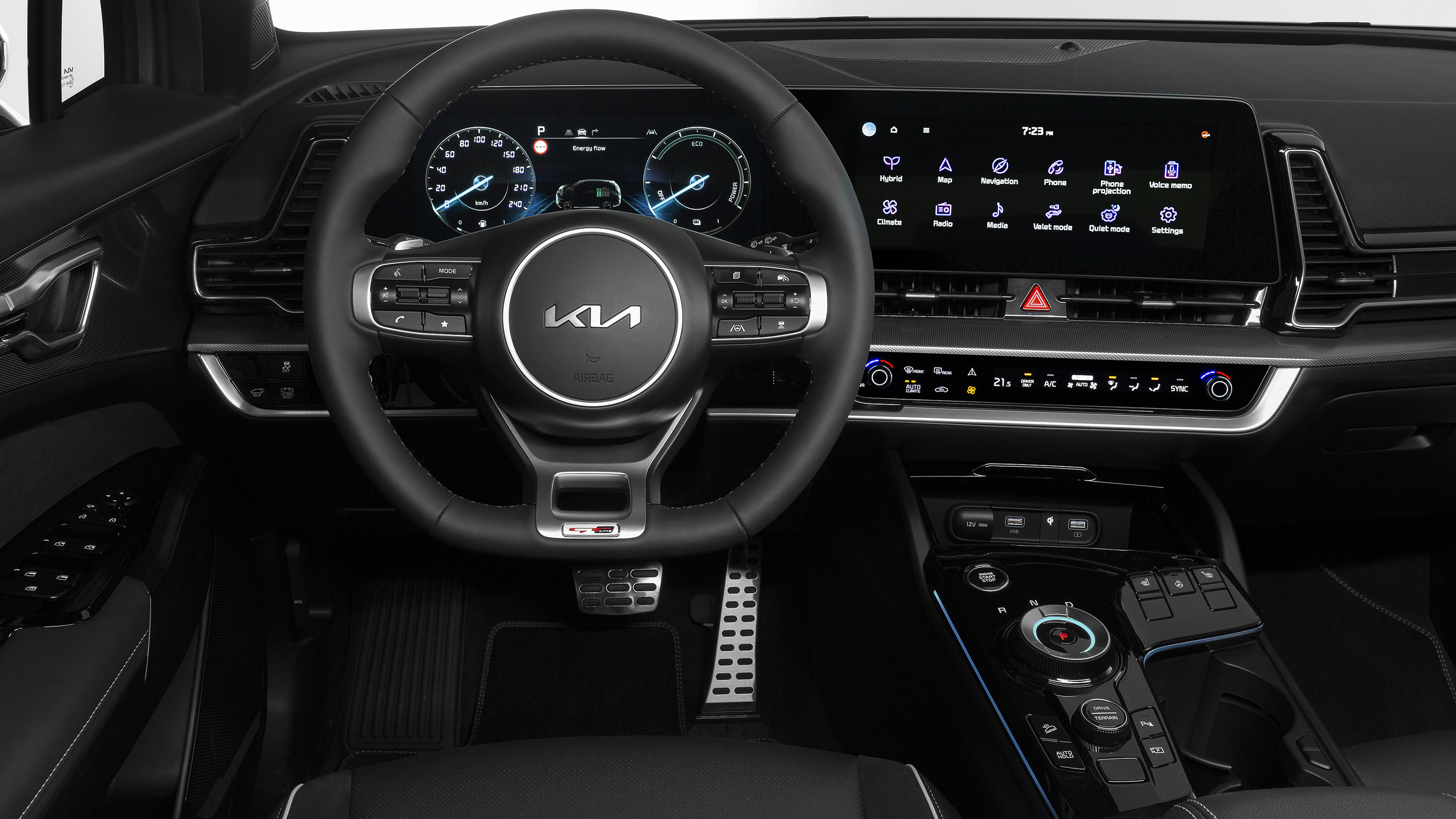 A steering wheel and dual displays inside the cabin of a car