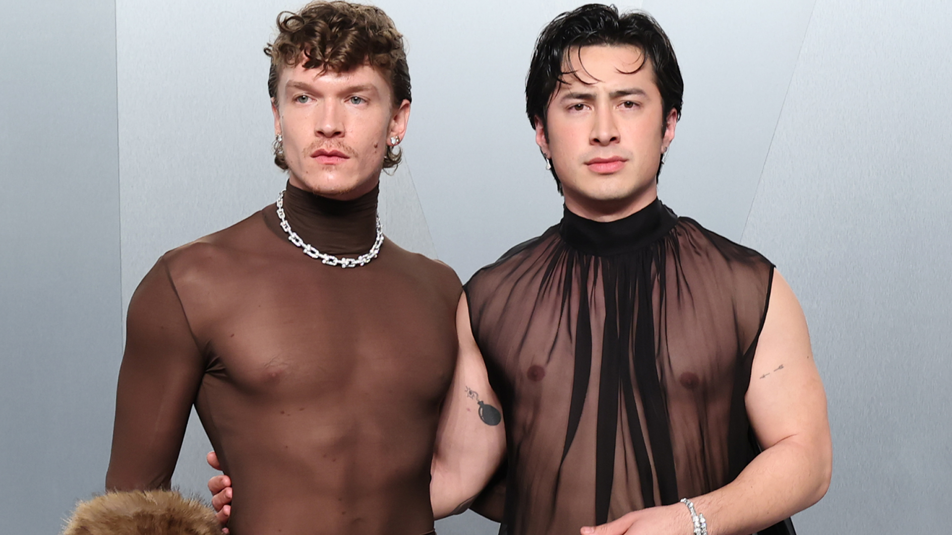 Hudson Williams and Connor Storrie coordinated at the 2026 Vanity Fair Oscar Party in matching naked shirts