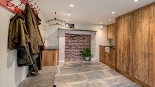 large utility and boot room with rustic timber cladding and spotlights