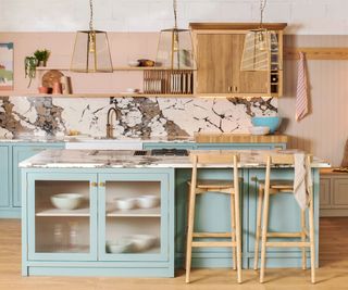 Blue and pink kitchen with a plate rack integrated into the floating shelving