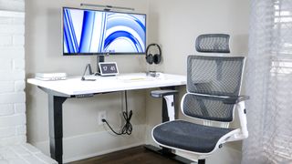 The Uppeal 2 Leg Desk with an office chair next to it