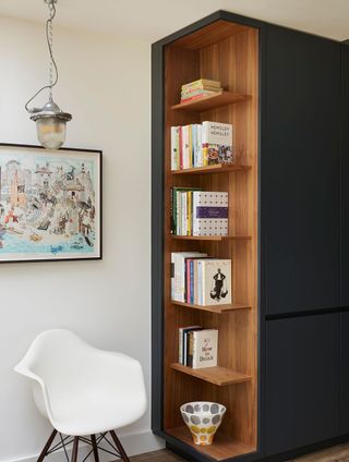 A slim bookshelf at the end of a kitchen cabinetry is a great kitchen storage idea