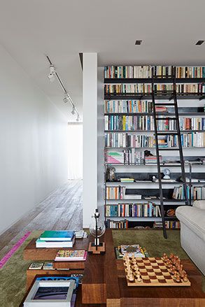 Display of art and books on a bookshelf and coffee table